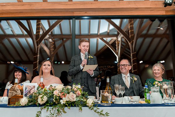 Man giving speech at wedding reception.