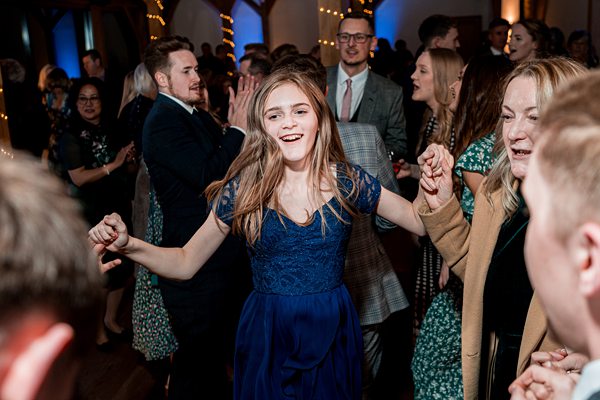 Joyful dance at lively indoor party.
