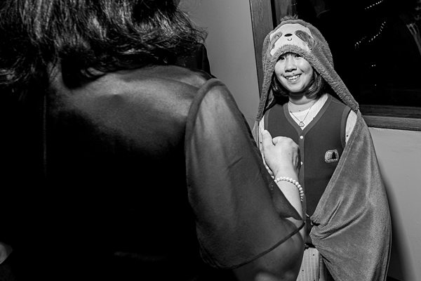 Woman smiling in animal-themed hooded blanket.
