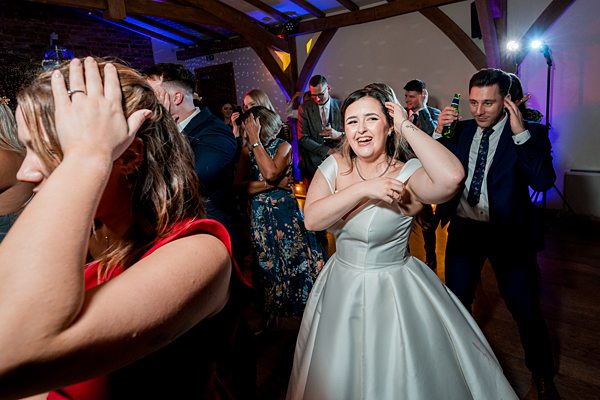 Wedding guests dancing and celebrating.