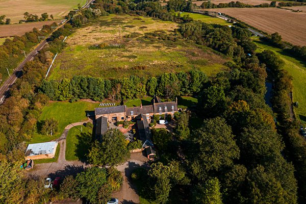 Aerial view of a rural estate with greenery in UK.