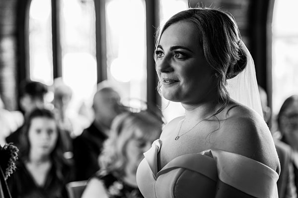 Bridal portrait in black and white at wedding ceremony.