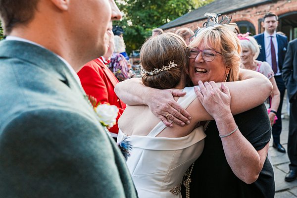 Joyful wedding hug with family.