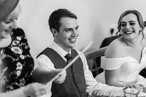 Three people laughing at a joyful gathering.