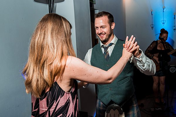 Couple dancing at evening event.