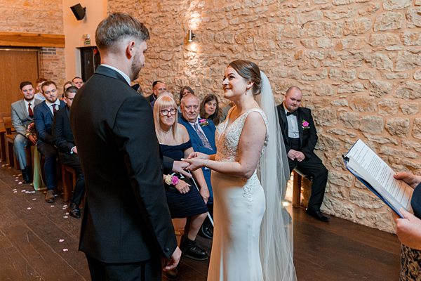 Couple exchanging vows at wedding ceremony.