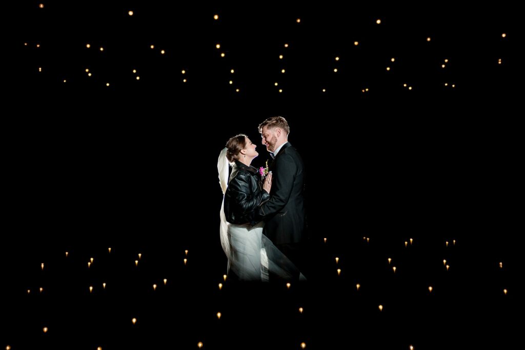 Couple sharing moment in starlit darkness.