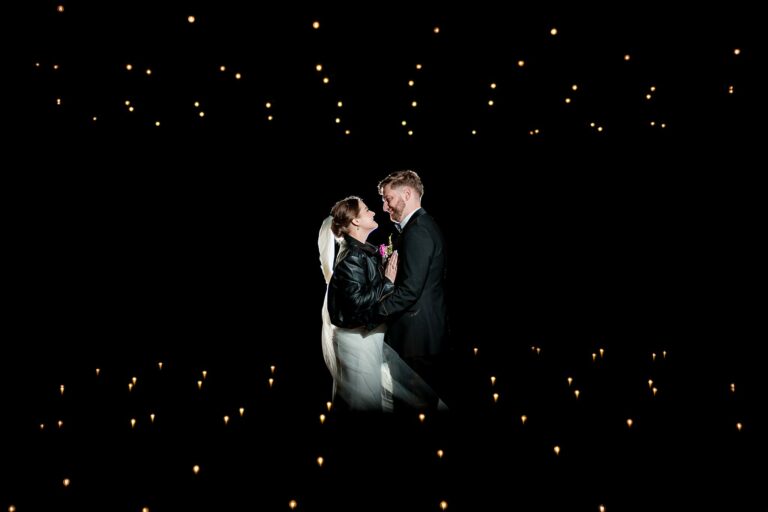 Couple sharing moment in starlit darkness.