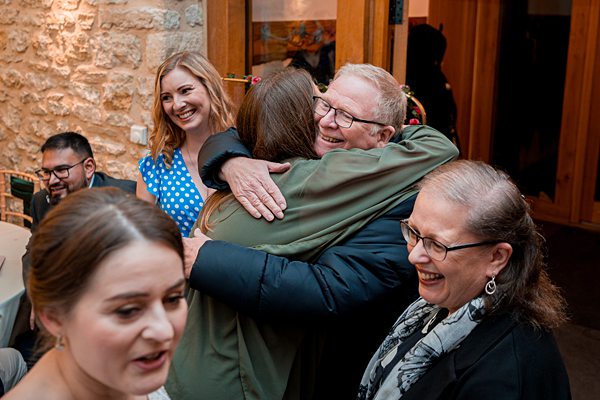 Joyful family reunion with warm embrace and smiles.