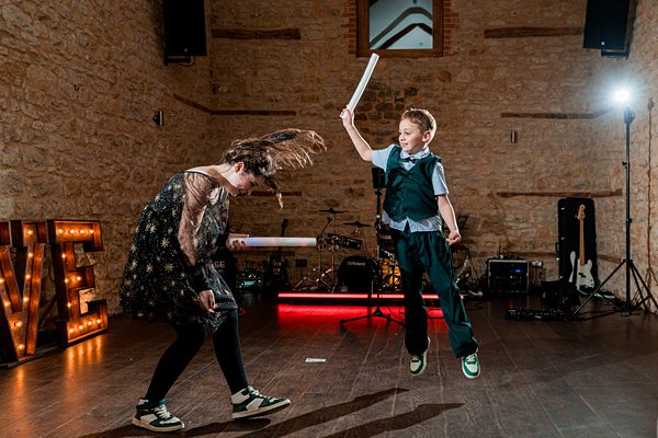 Child and adult dancing at a festive event.