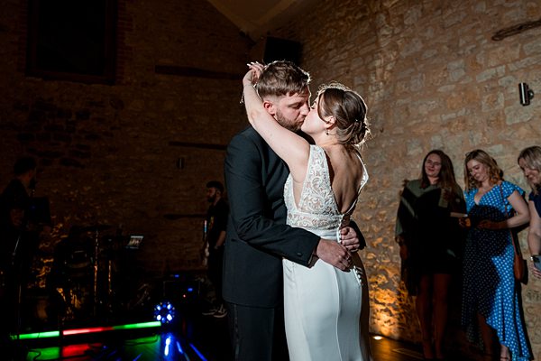 Bride and groom sharing first dance at wedding reception.