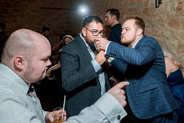 Men interacting at a social event.