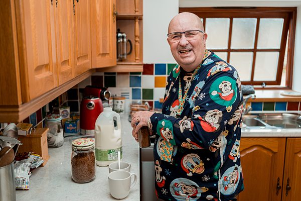Man making tea in home kitchen.
