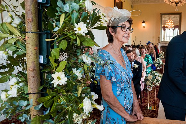 Woman in fascinator at wedding ceremony.