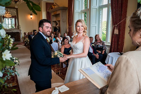 Happy couple exchanging vows at elegant wedding.