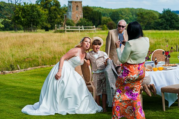 Bride and guests enjoying outdoor wedding celebration.