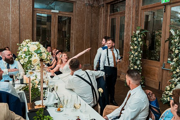 Bride and groom laughing at wedding reception.