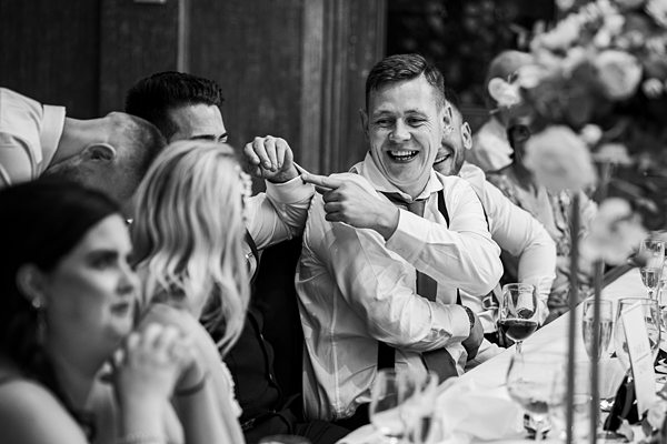 Guests laughing at wedding reception.