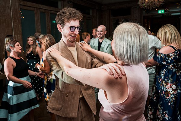 Couple dancing joyfully at a lively party.