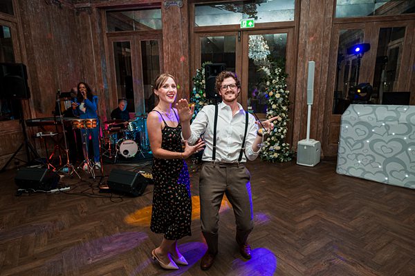 Couple dancing at a wedding reception with live band.