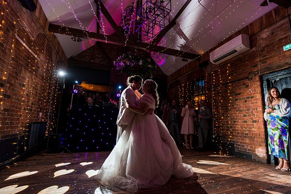 Couple's first dance at rustic wedding venue.