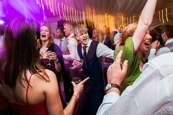 People enjoying a lively wedding reception dance.