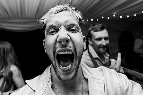 Man shouting excitedly at a party event.