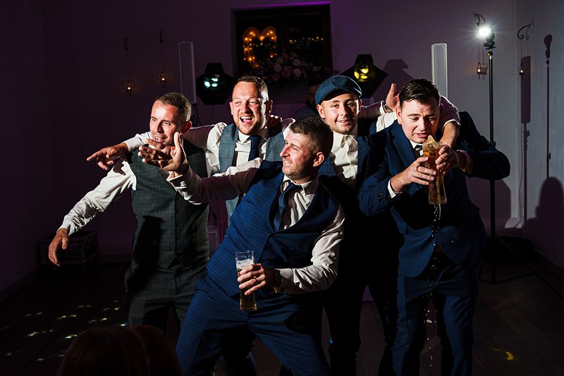 Men dancing at wedding reception party.