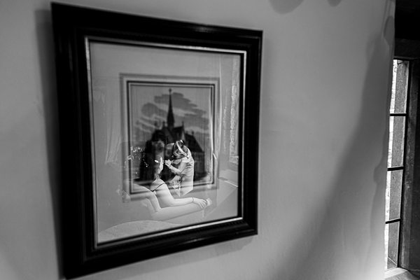 Monochrome framed photo on wall, reflective glass.
