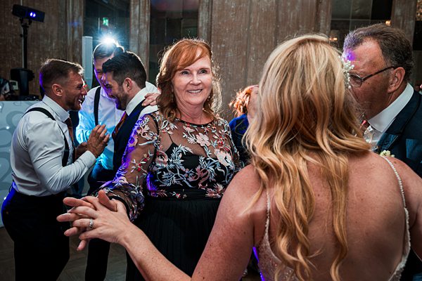 Guests enjoying dance at wedding reception.