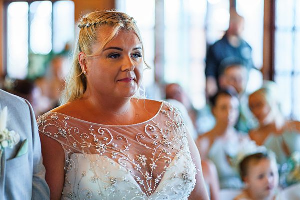 Bride in embroidered dress at wedding ceremony.