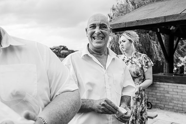 Smiling man enjoying outdoor social event.