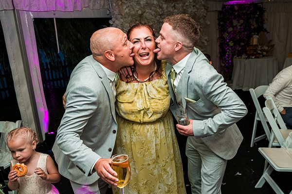 Joyful wedding guests sharing a cheerful moment.