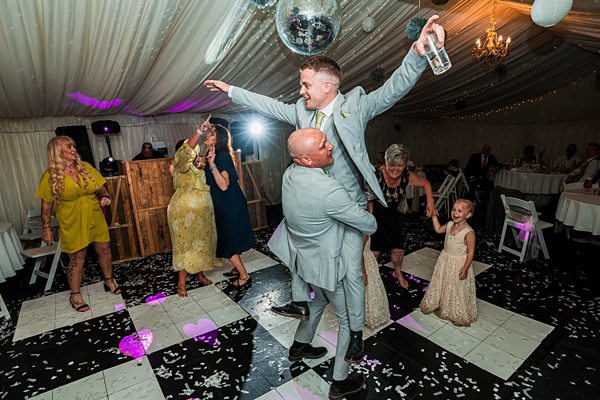 Wedding celebration dance with joyful guests.