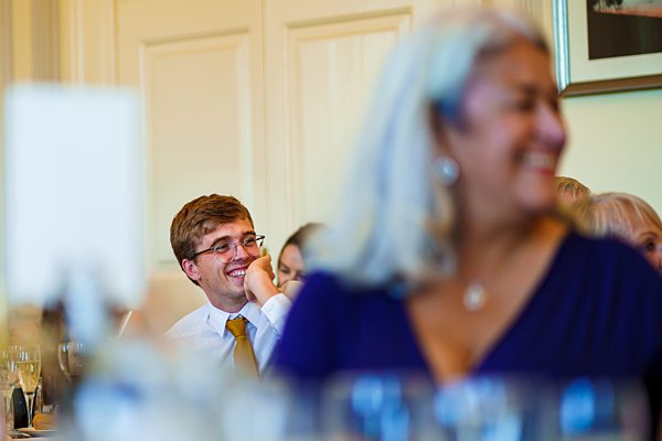 Man smiling in elegant dining event.