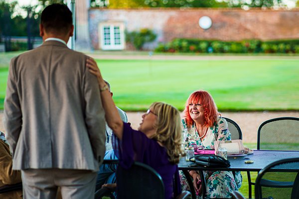 Guests chatting at outdoor event.