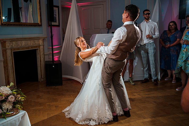 Bride and groom enjoying first dance at wedding reception.