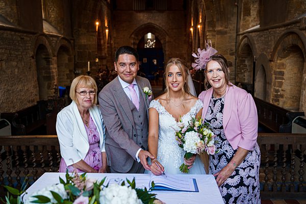 Wedding ceremony signing with family in church