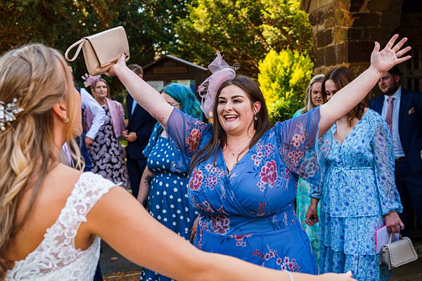 Guests enjoying at sunny British wedding ceremony.
