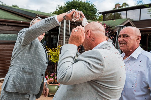 Men celebrating with confetti and joyful expressions.