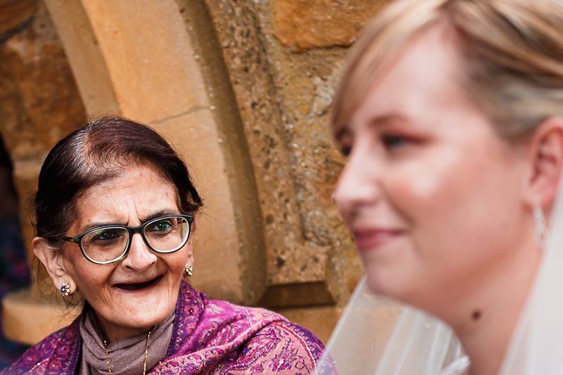 Two women smiling at each other warmly.