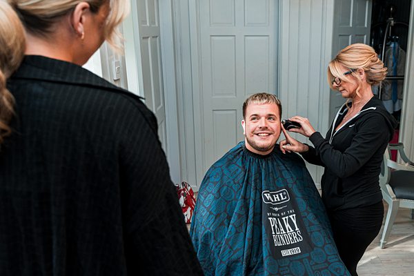 Man getting haircut in modern barbershop.