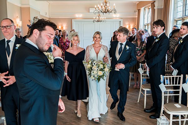 Wedding ceremony with emotional guests and happy couple.