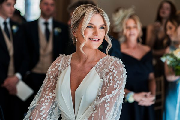 Bride smiling during wedding ceremony.