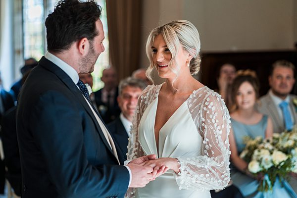 Bride and groom exchanging vows at wedding ceremony.