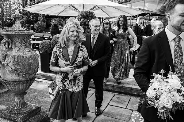 Guests smiling at outdoor wedding event.
