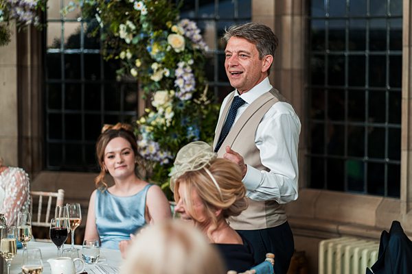 Man giving speech at wedding reception.
