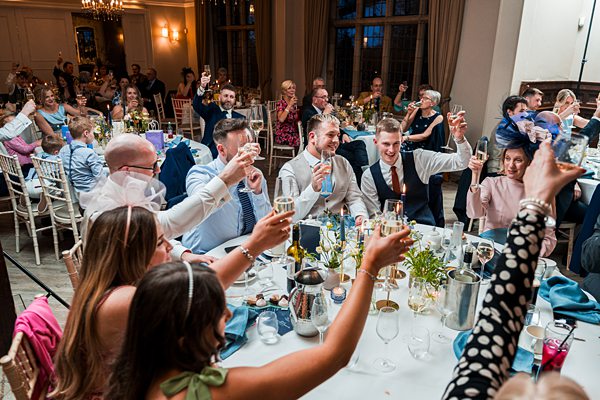 Guests toasting at a wedding reception.