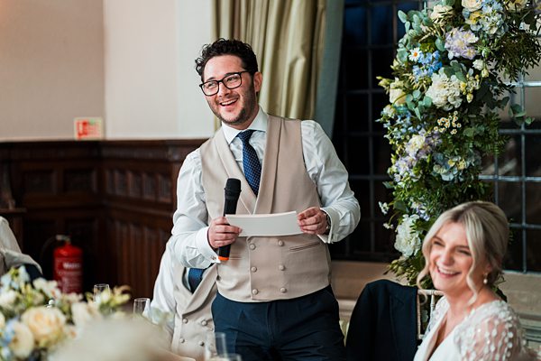 Man giving speech at wedding reception.