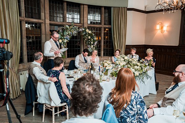 Wedding speech at the reception with guests listening.
